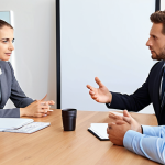 **Business meeting in progress, focus on clear and concise communication. People at a table, one person speaking confidently, minimal jargon, emphasis on understanding. Bright, professional setting.**